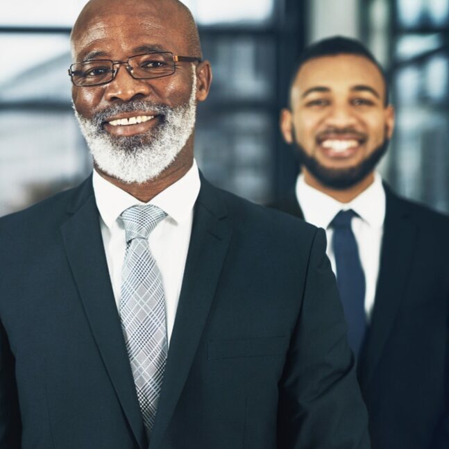 Portrait of a team of confident business executives standing together in a modern office